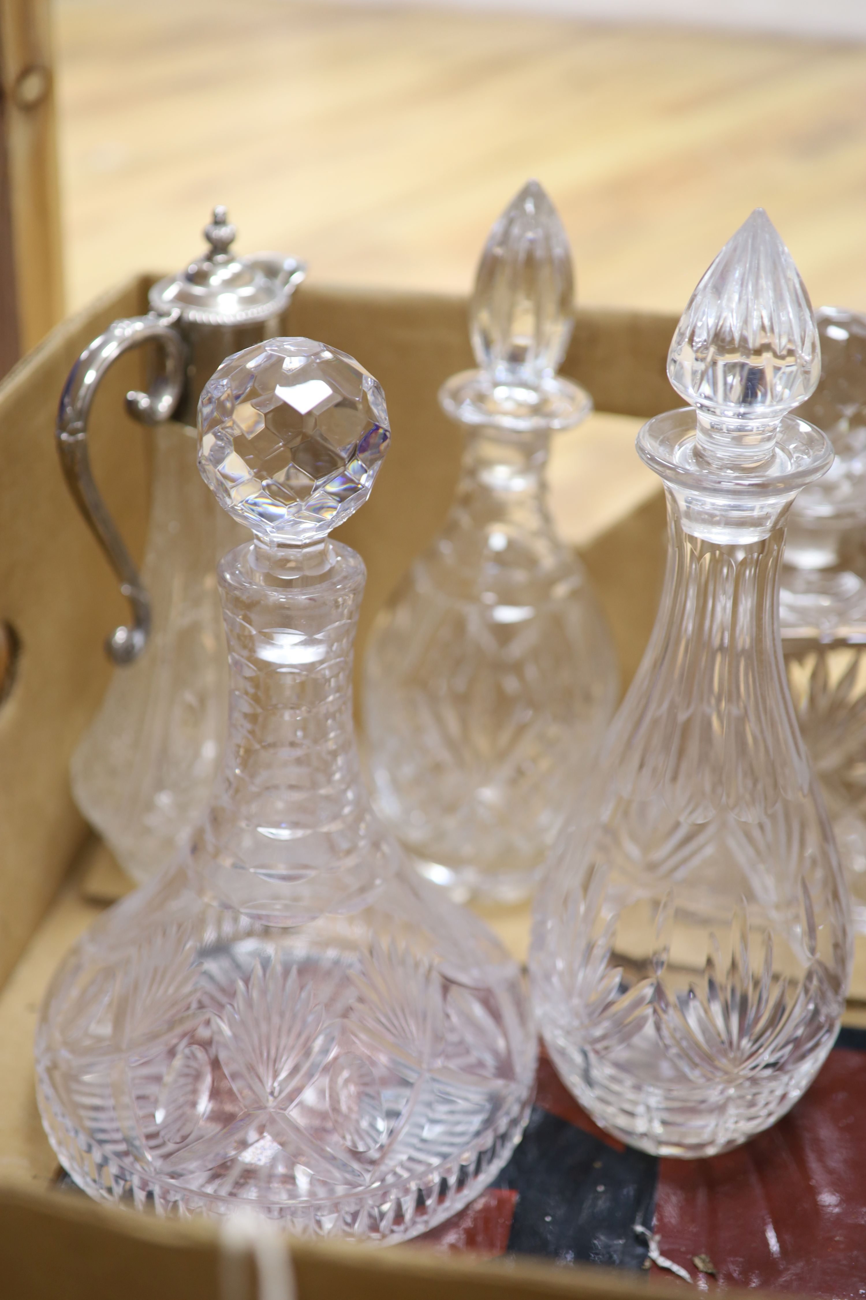 Five various glass decanters and a similar claret jug